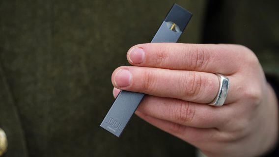 Hand holding a JUUL e-cigarette