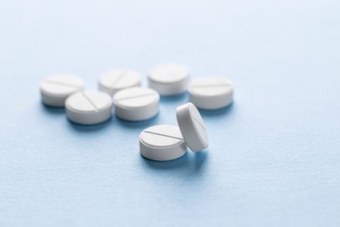 Generic pills scattered on surface
