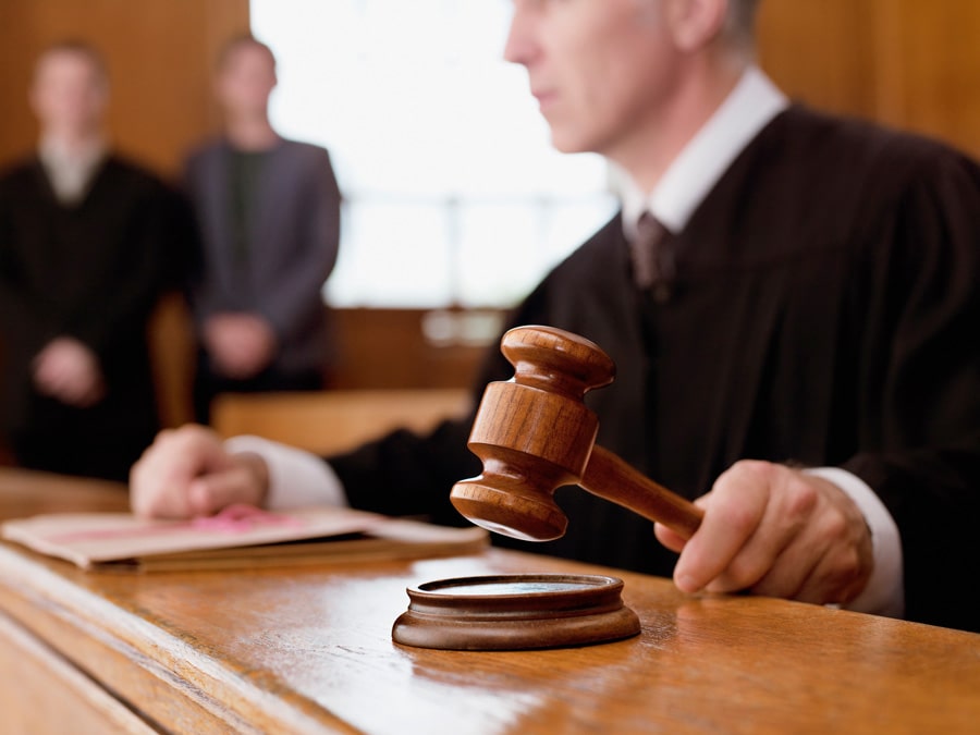 Judge holding gavel in courtroom