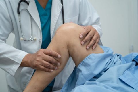 Doctor examining knee