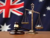 Gavel and scales with Australia flag background