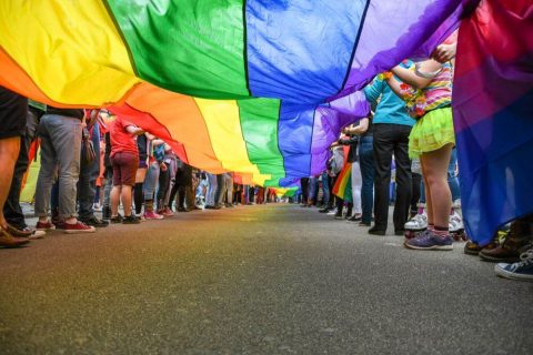 lgbtq+ group holding a rainbow flag