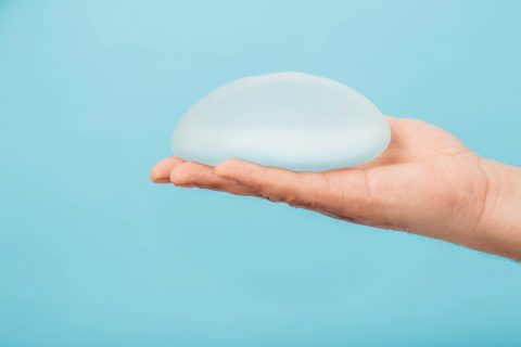 Man holding breast implant
