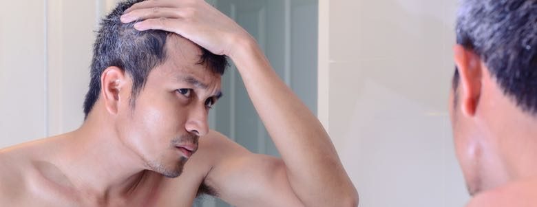 man checking gray hairs