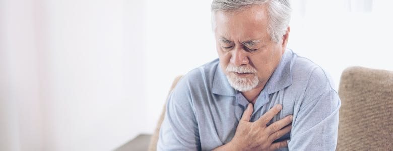 Elderly man experiencing a heart attack