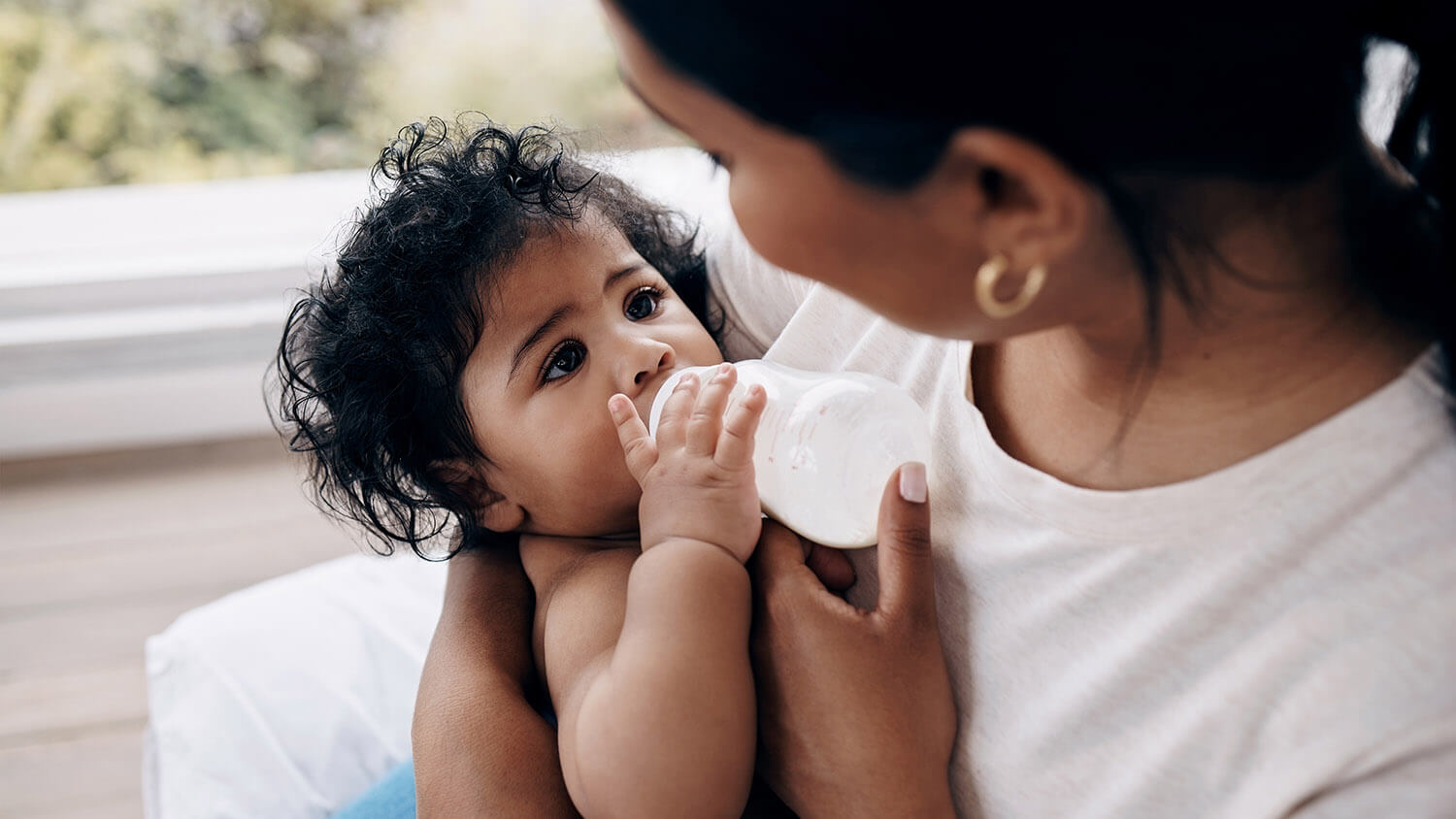 mother feeding child baby formula