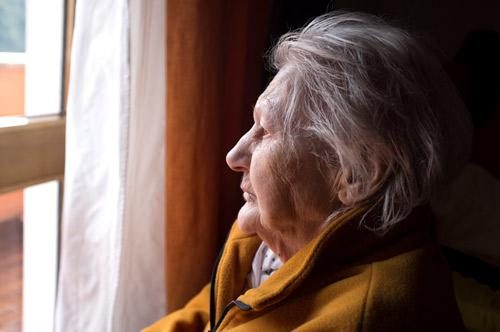 Older Woman Staring Out Window