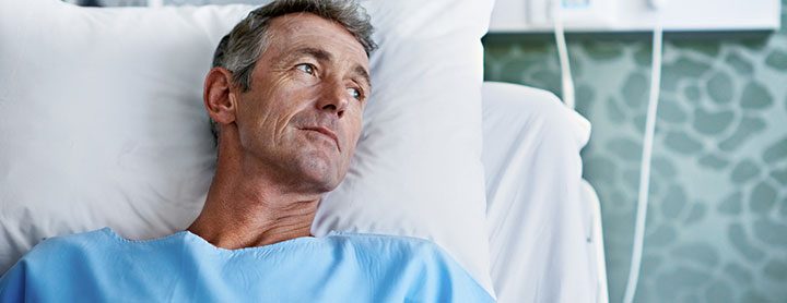 Older man resting in hospital bed