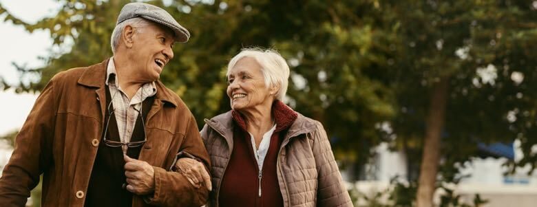 senior couple walking in the park