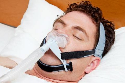 Man sleeping with CPAP machine