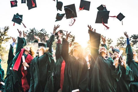 graduates throwing hats in the air