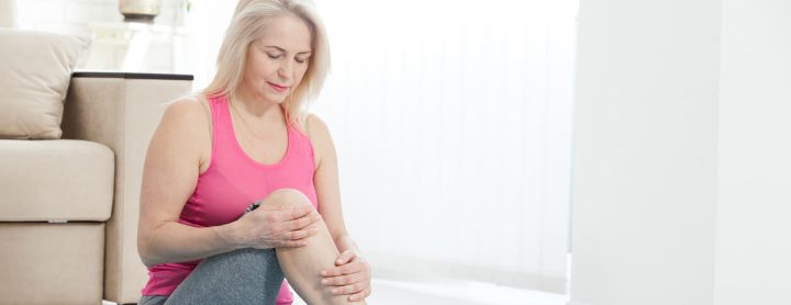Woman feeling pain in her knee while working out