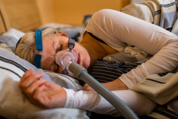 Woman using a CPAP machine