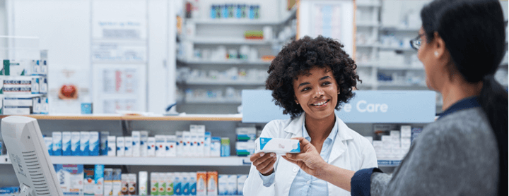Pharmacist explaining drug label to customer